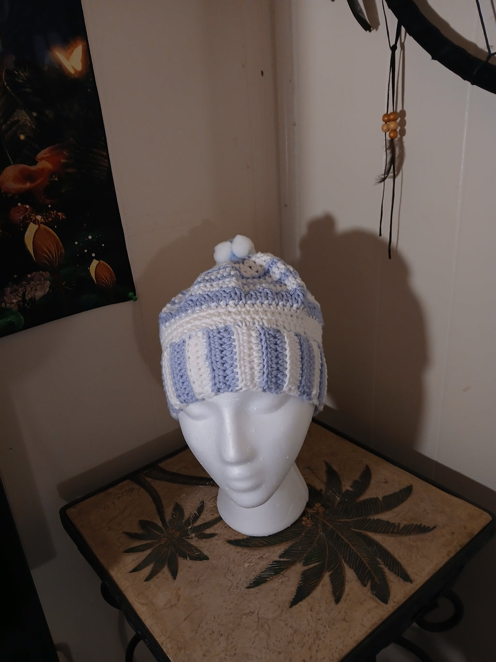 White and light blue crochet Adult Hat with sewn-together small pompoms