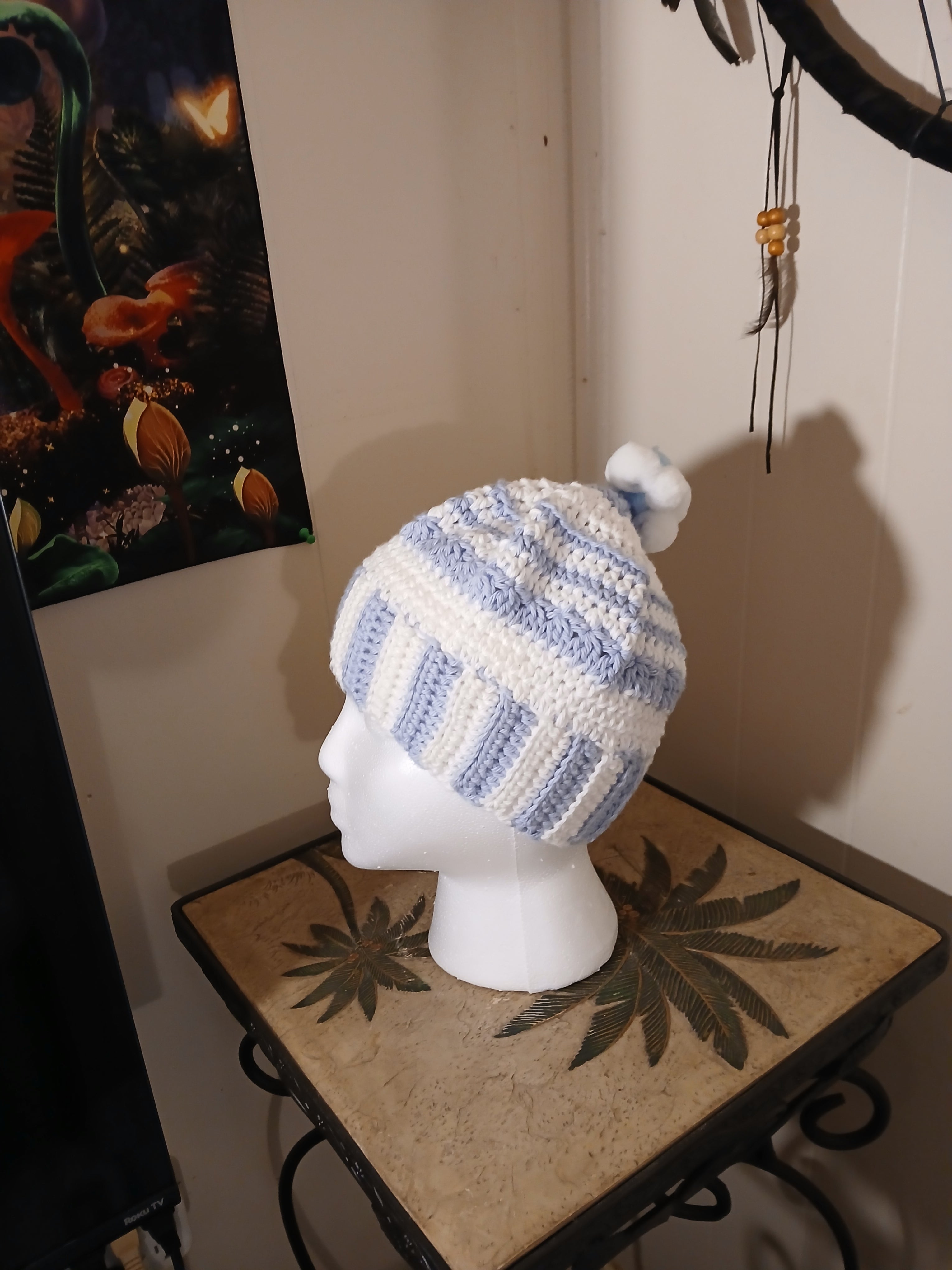 White and light blue crochet Adult Hat with sewn-together small pompoms