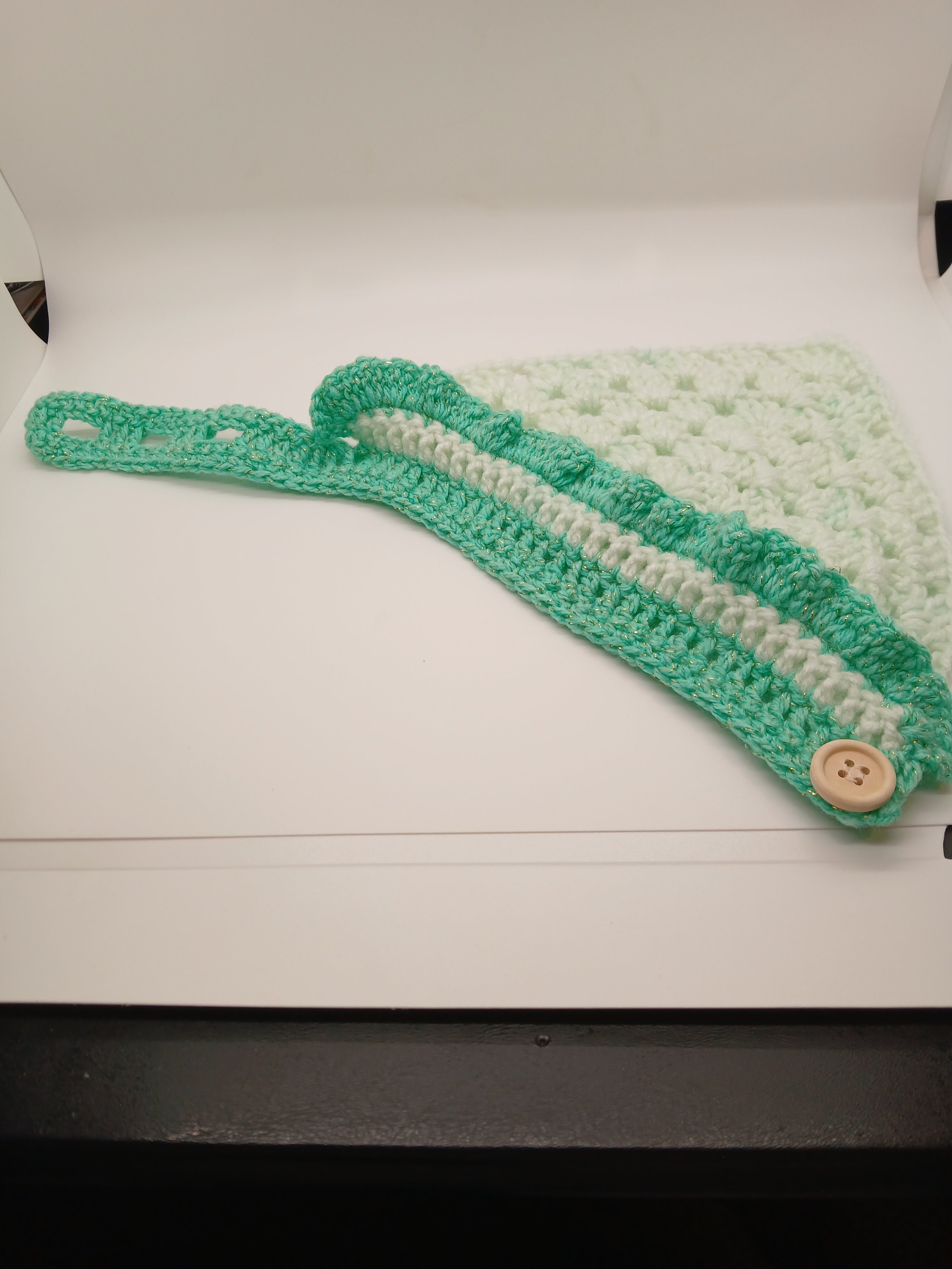 Adjustable crochet dog bandana with button closure in green hues